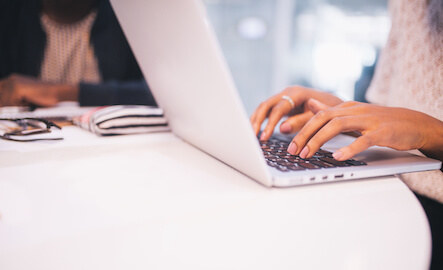 woman typing on laptop